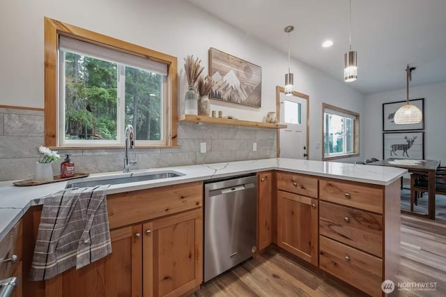 41 Hawkeye, Ronald, WA 98940 - kitchen with a sink, a peninsula, light wood-type flooring, stainless steel dishwasher, and hanging light fixtures