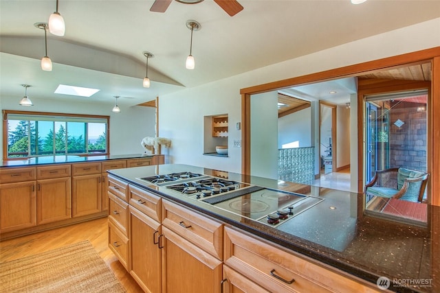 97 Snowberry Ln, Orcas Island, WA 98245 - kitchen featuring a skylight, vaulted ceiling, light wood finished floors, hanging light fixtures, and black electric cooktop