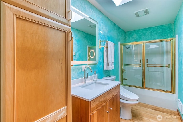 97 Snowberry Ln, Orcas Island, WA 98245 - bathroom with vanity, wood finished floors, and combined bath / shower with glass door