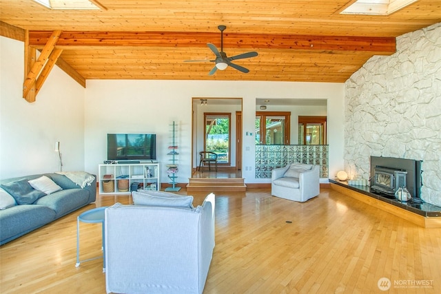97 Snowberry Ln, Orcas Island, WA 98245 - living area featuring a skylight, a wood stove, wood finished floors, ceiling fan, and wood ceiling