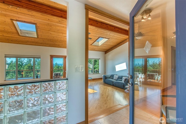 97 Snowberry Ln, Orcas Island, WA 98245 - living area featuring a skylight, tile patterned flooring, french doors, high vaulted ceiling, and a wooden ceiling with exposed beams