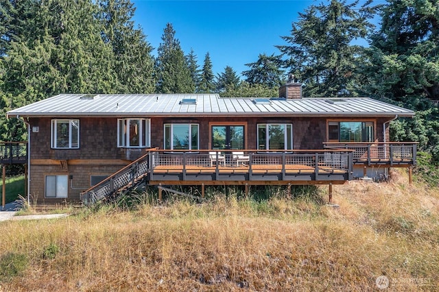 97 Snowberry Ln, Orcas Island, WA 98245 - back of house with a standing seam roof, a chimney, a metal roof, and a deck
