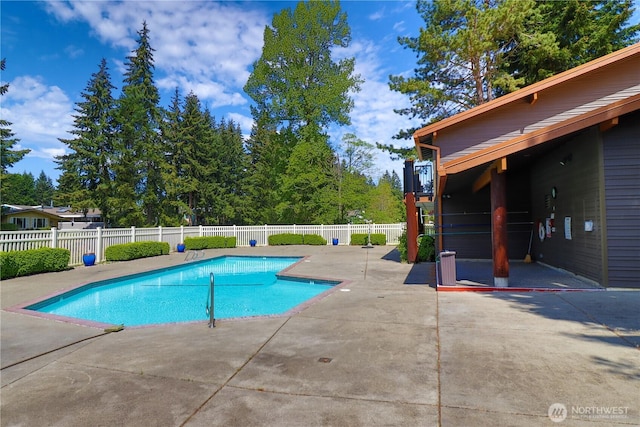 view of pool with a patio, a fenced in pool, and fence