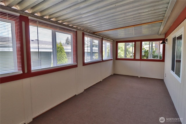 unfurnished sunroom featuring carpet
