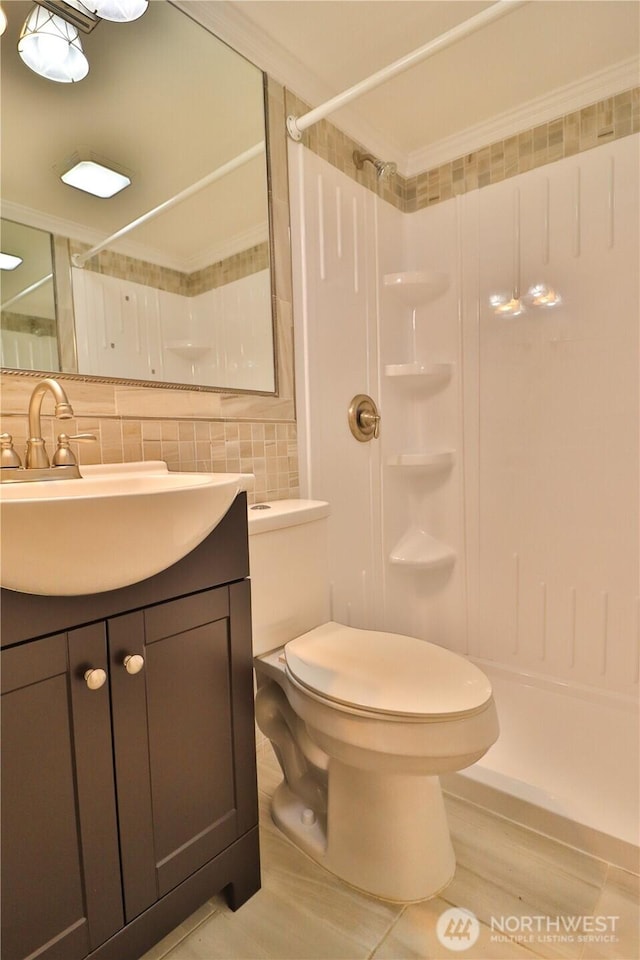 bathroom featuring vanity, decorative backsplash, a shower, toilet, and tile patterned floors