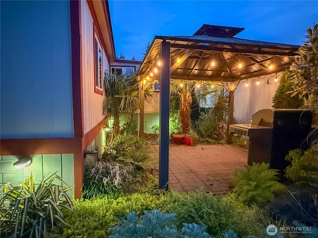 patio at night featuring a gazebo