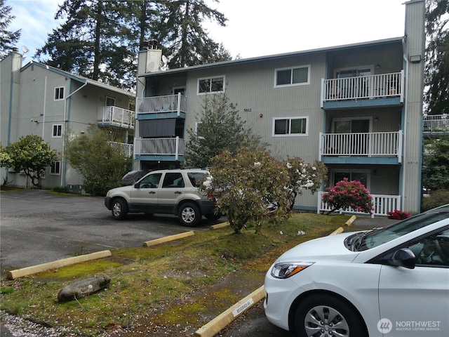 view of building exterior featuring uncovered parking