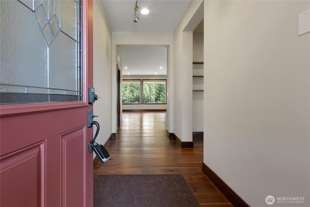 interior space with baseboards and dark wood finished floors