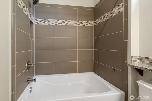 bathroom featuring  shower combination and toilet