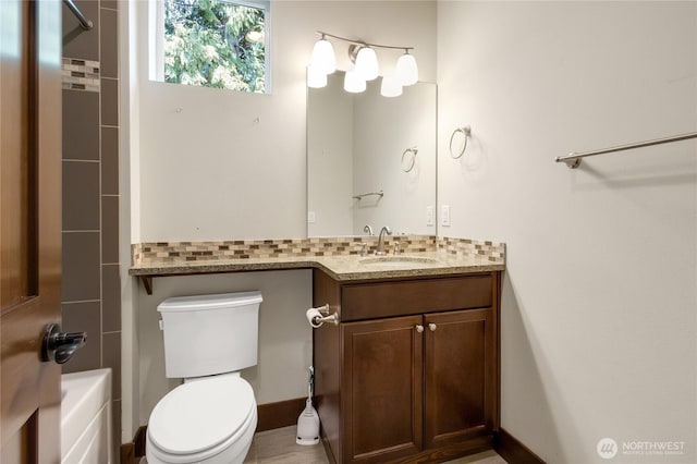 full bath featuring vanity and toilet