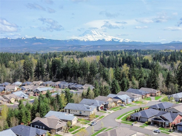 bird's eye view featuring a view of trees, a residential view, and a mountain view
