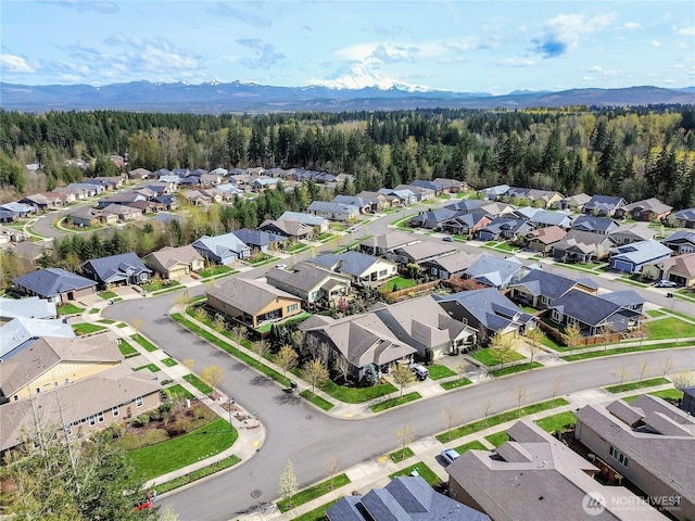 bird's eye view featuring a residential view, a view of trees, and a mountain view