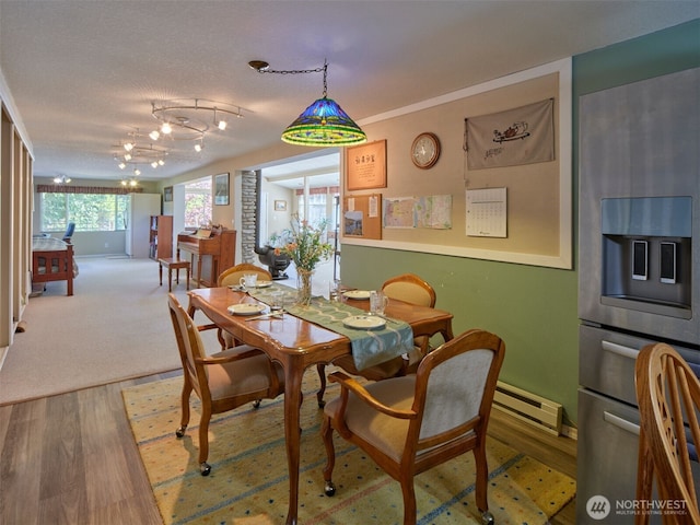 597 Yale Bridge Rd, Ariel, WA 98603 - dining space with wood finished floors, baseboards, and a baseboard heating unit