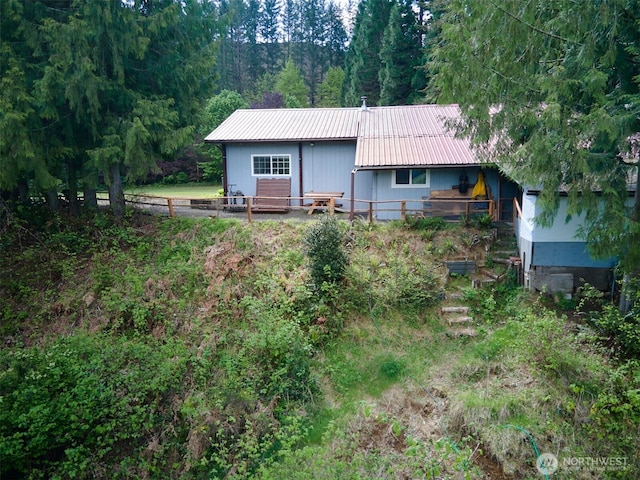 597 Yale Bridge Rd, Ariel, WA 98603 - back of house featuring fence, metal roof, and a forest view