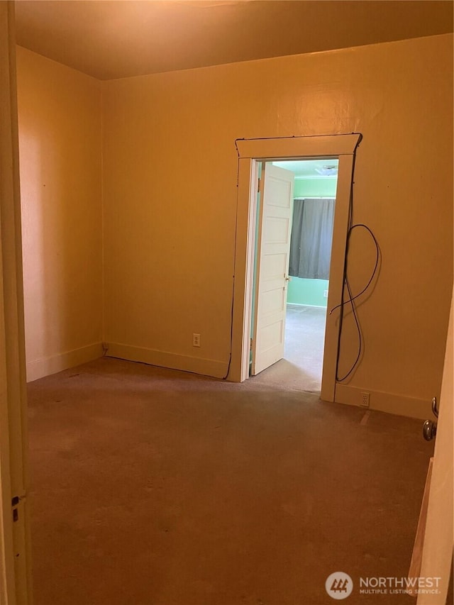 spare room with carpet floors and baseboards