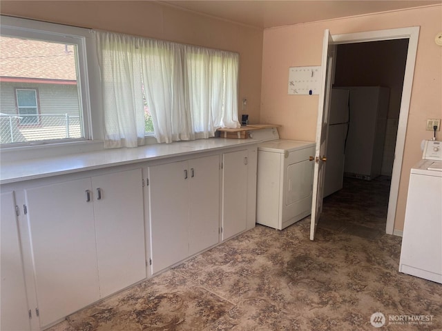 washroom featuring cabinet space and washer / clothes dryer