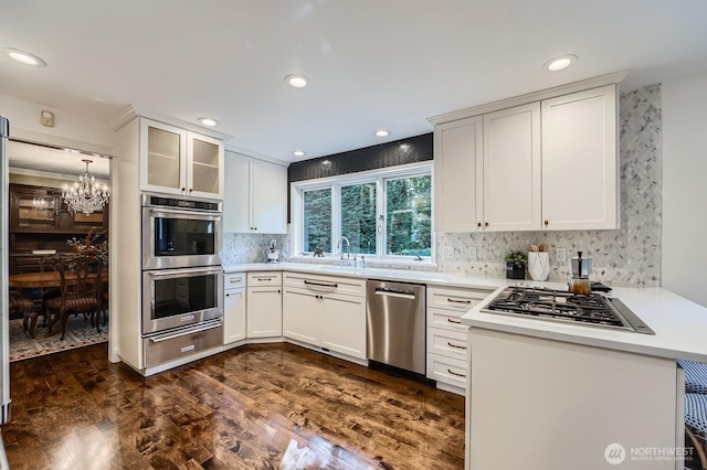 3123 240th Ave NE, Sammamish, WA 98074 - kitchen with light countertops, tasteful backsplash, a sink, a warming drawer, and stainless steel appliances