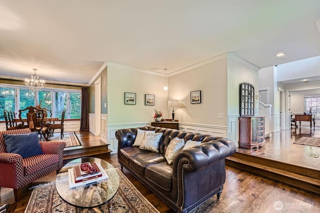 3123 240th Ave NE, Sammamish, WA 98074 - living area featuring crown molding, wainscoting, a decorative wall, dark wood-type flooring, and a notable chandelier