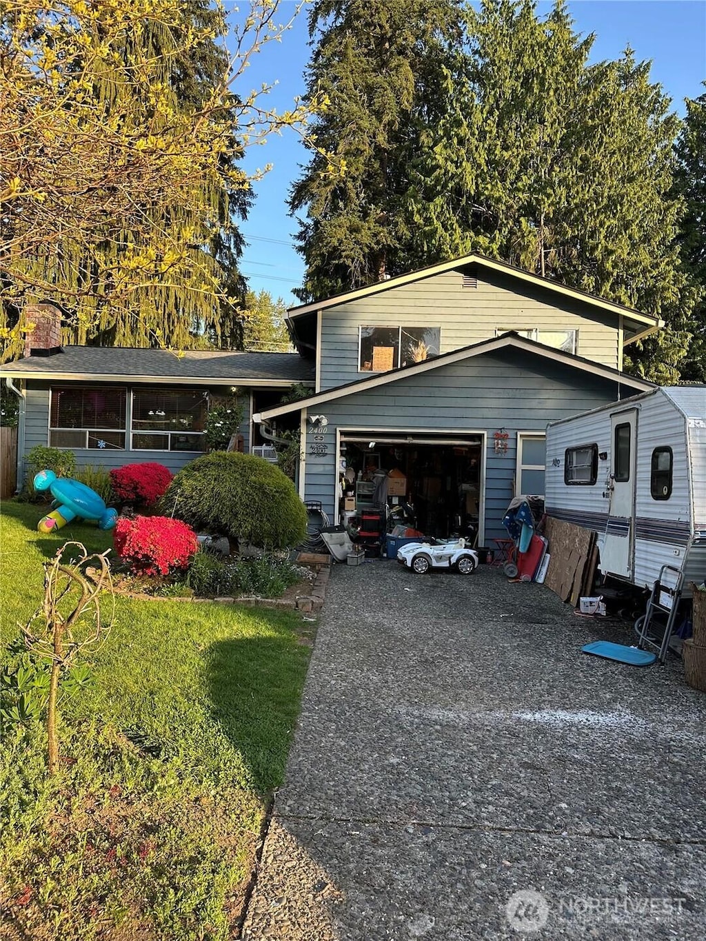 split level home featuring concrete driveway and a garage