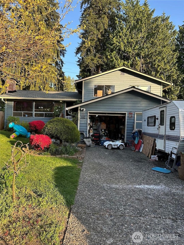 split level home featuring concrete driveway and a garage
