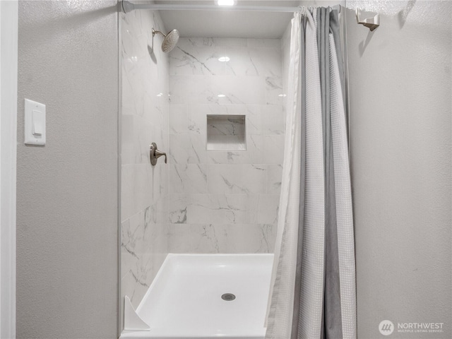 bathroom with a shower stall