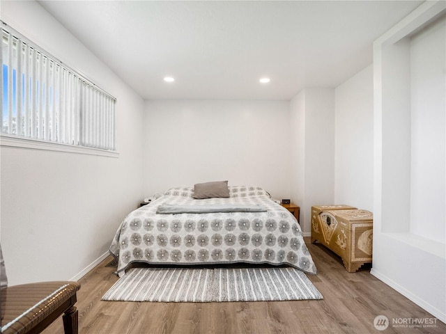 bedroom featuring baseboards, recessed lighting, and wood finished floors