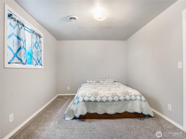 bedroom featuring baseboards, visible vents, and carpet