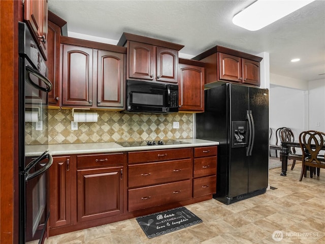 kitchen featuring light countertops, backsplash, black appliances, and reddish brown cabinets