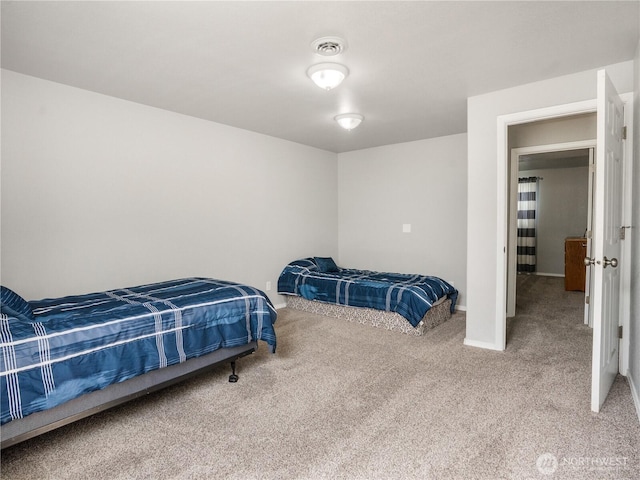carpeted bedroom with baseboards and visible vents