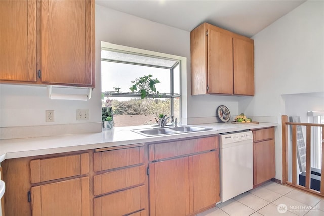 kitchen with light countertops, light tile patterned floors, a sink, and dishwasher