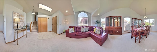 living room with lofted ceiling with skylight, plenty of natural light, and carpet