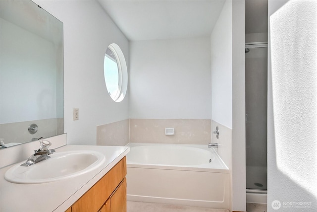 bathroom with a shower stall, a garden tub, and vanity