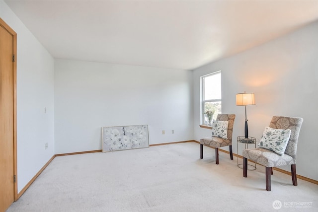 living area featuring carpet flooring and baseboards