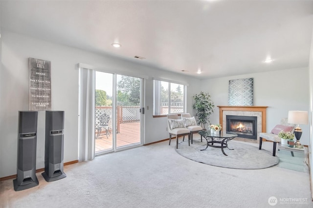 carpeted living room with baseboards, recessed lighting, a tile fireplace, and visible vents