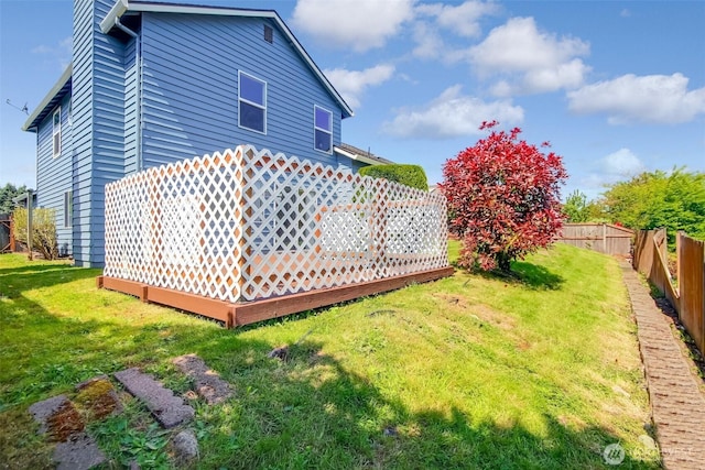 view of yard featuring fence and a deck