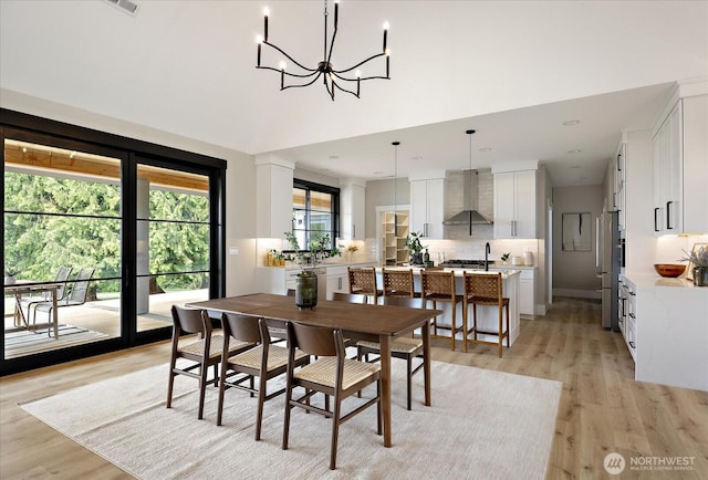 4306 Quaternary Rd, Clinton, WA 98236 - dining space with recessed lighting, a high ceiling, a notable chandelier, and light wood-style flooring