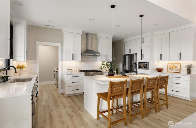 4306 Quaternary Rd, Clinton, WA 98236 - kitchen featuring a sink, wall chimney exhaust hood, appliances with stainless steel finishes, and backsplash