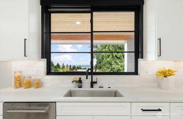 4306 Quaternary Rd, Clinton, WA 98236 - interior space with decorative backsplash, light countertops, white cabinetry, a sink, and dishwasher