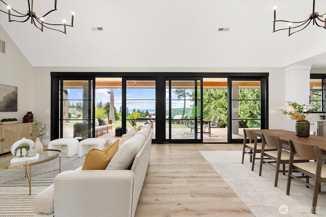 4306 Quaternary Rd, Clinton, WA 98236 - living area featuring light wood-style floors, a notable chandelier, high vaulted ceiling, and visible vents