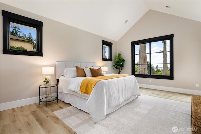 4306 Quaternary Rd, Clinton, WA 98236 - bedroom featuring baseboards, vaulted ceiling, and light wood-type flooring