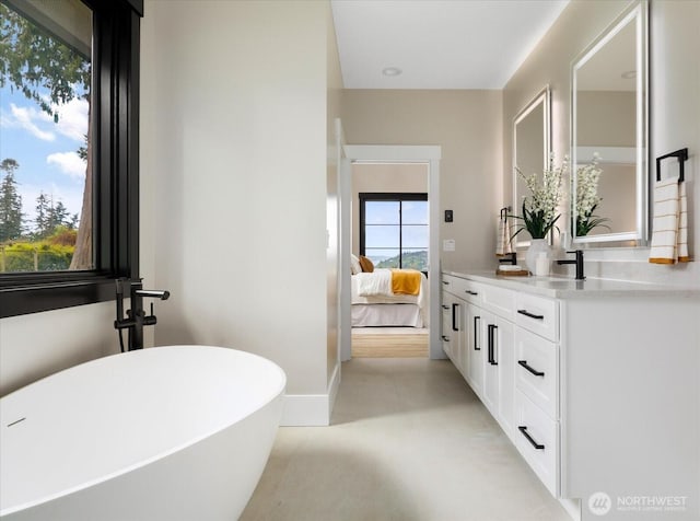 4306 Quaternary Rd, Clinton, WA 98236 - bathroom with a freestanding tub, baseboards, vanity, and connected bathroom