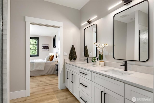 4306 Quaternary Rd, Clinton, WA 98236 - bathroom with double vanity, a sink, connected bathroom, and wood finished floors