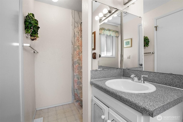 bathroom with tile patterned floors, vanity, and curtained shower