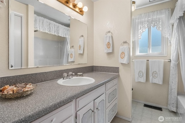 full bathroom featuring visible vents, baseboards, tile patterned floors, and vanity