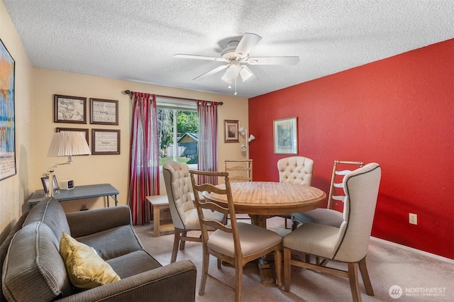 dining area featuring a textured ceiling, ceiling fan, and light carpet