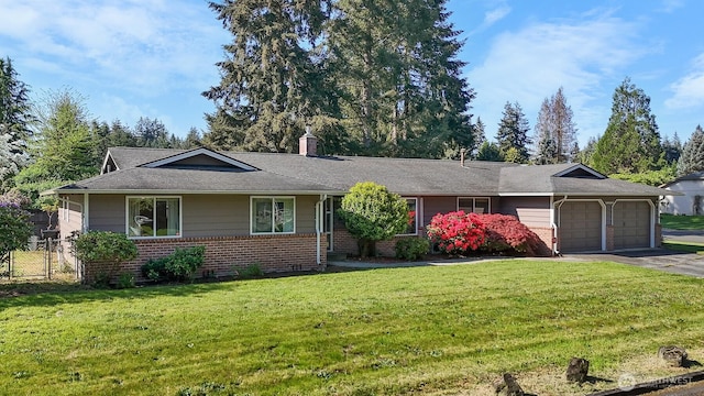 ranch-style house with a front lawn, aphalt driveway, a chimney, brick siding, and an attached garage