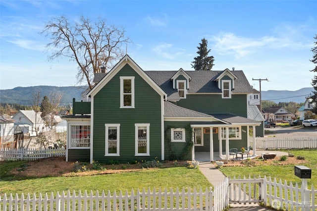 209 W 3rd St, Cle Elum, WA 98922 - view of front facade featuring a fenced front yard, roof with shingles, a chimney, and a front yard