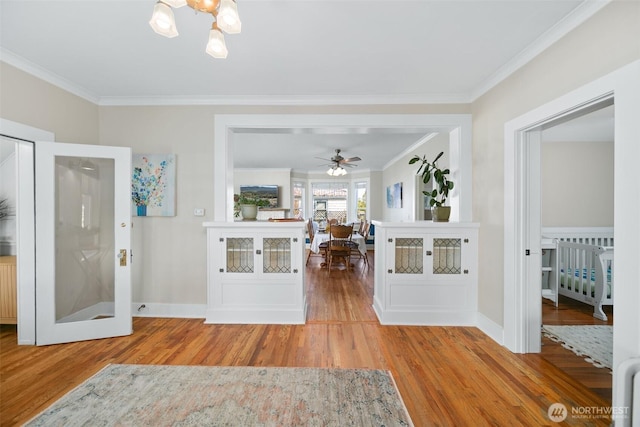209 W 3rd St, Cle Elum, WA 98922 - foyer with crown molding, baseboards, ceiling fan with notable chandelier, and wood finished floors