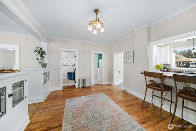 209 W 3rd St, Cle Elum, WA 98922 - foyer with crown molding, an inviting chandelier, light wood-style flooring, and radiator