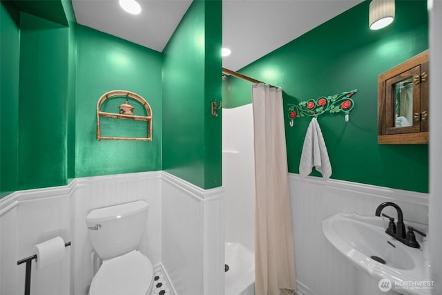 209 W 3rd St, Cle Elum, WA 98922 - bathroom featuring toilet, a stall shower, a sink, and a wainscoted wall